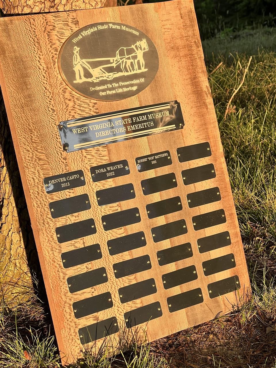 Large wooden perpetual plaque for West Virginia State Farm Museum Directors Emeritus with engraved plow scene and name plates