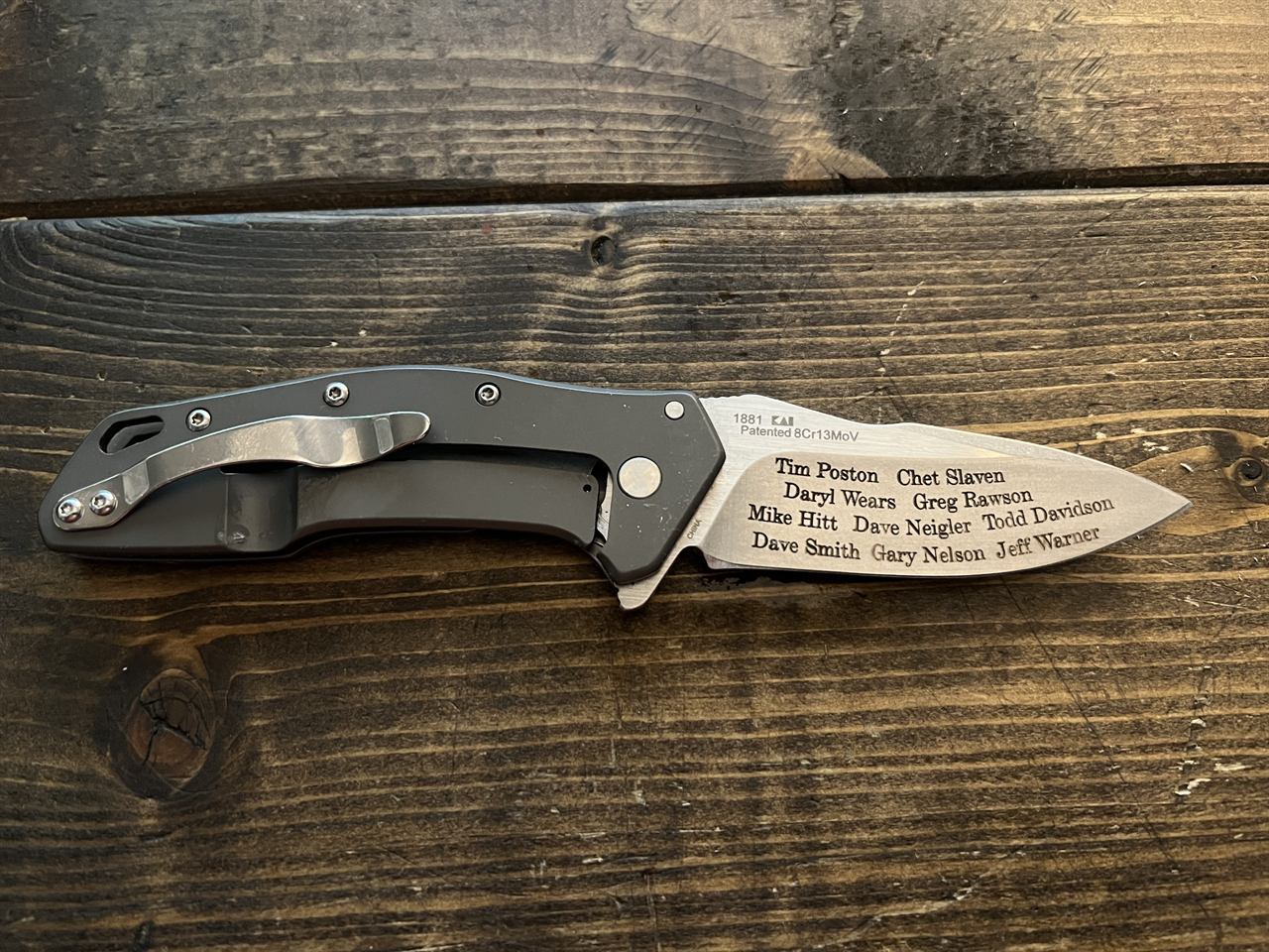 Folding knife blade engraved with a full roster of names