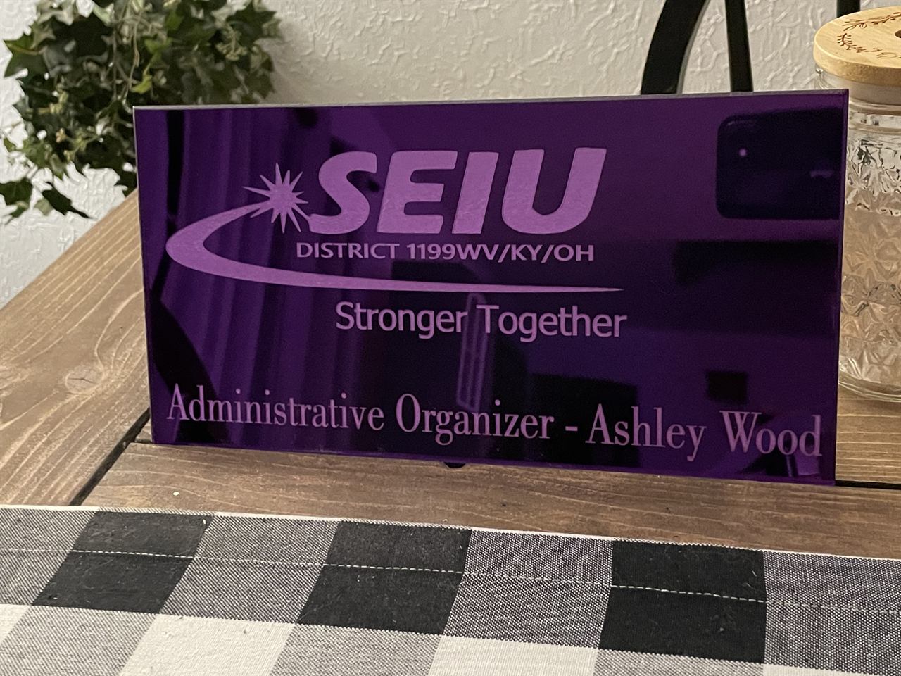 Purple acrylic SEIU District 1199 Stronger Together sign for Administrative Organizer Ashley Wood